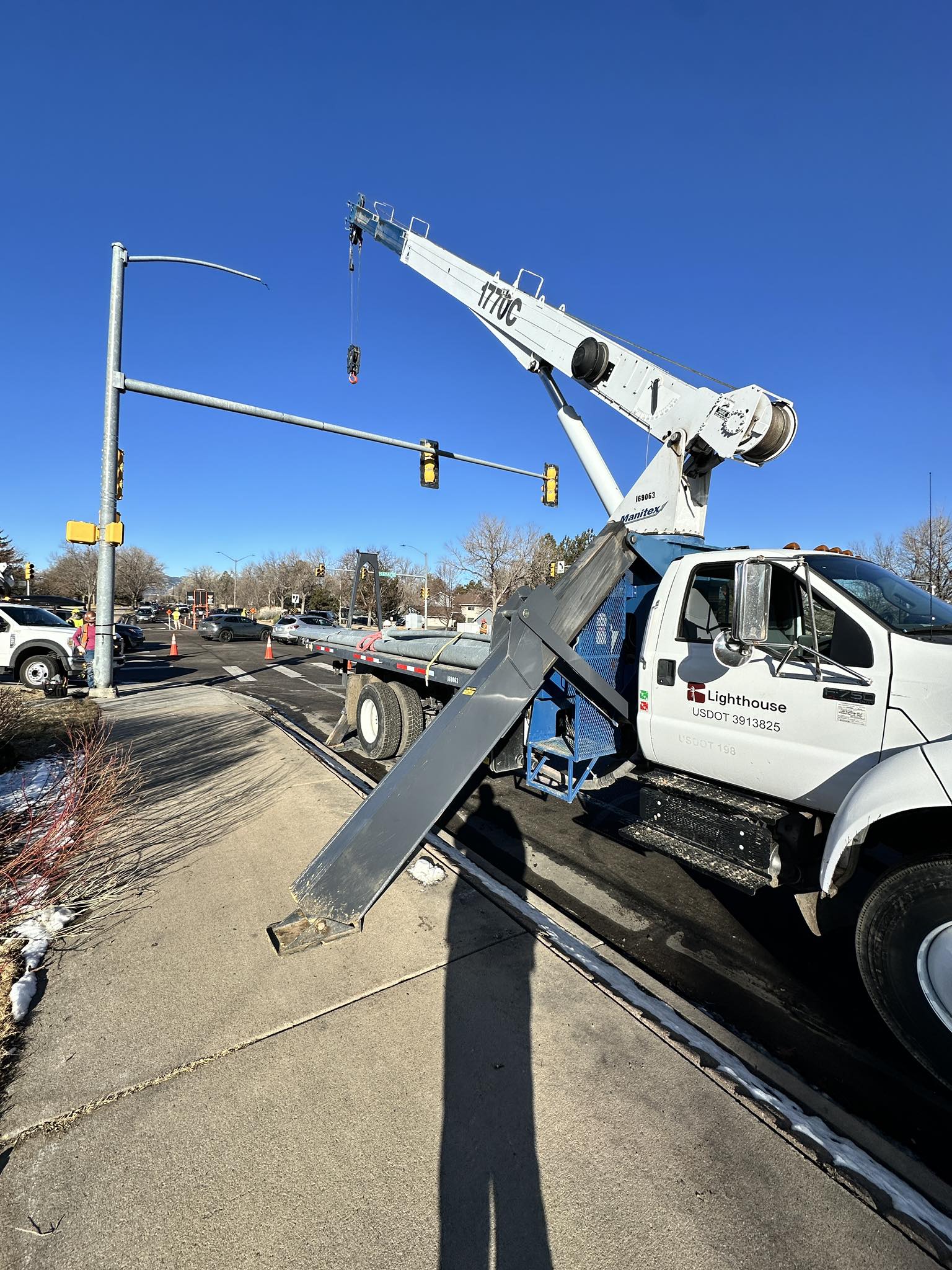 Utility crew performing street light installation in Littleton, CO