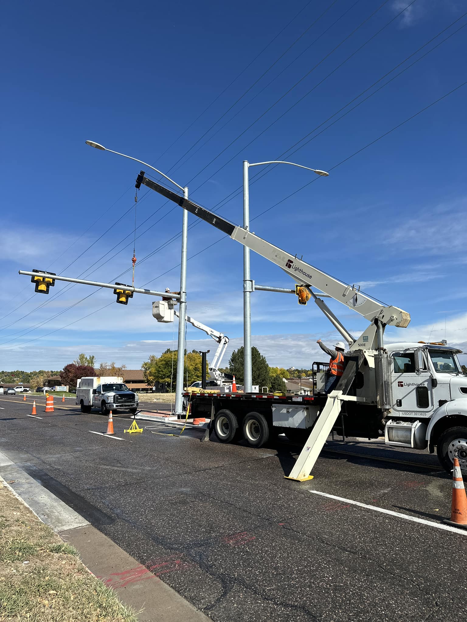 Technicians setting poles for street light installation in Northglenn, CO